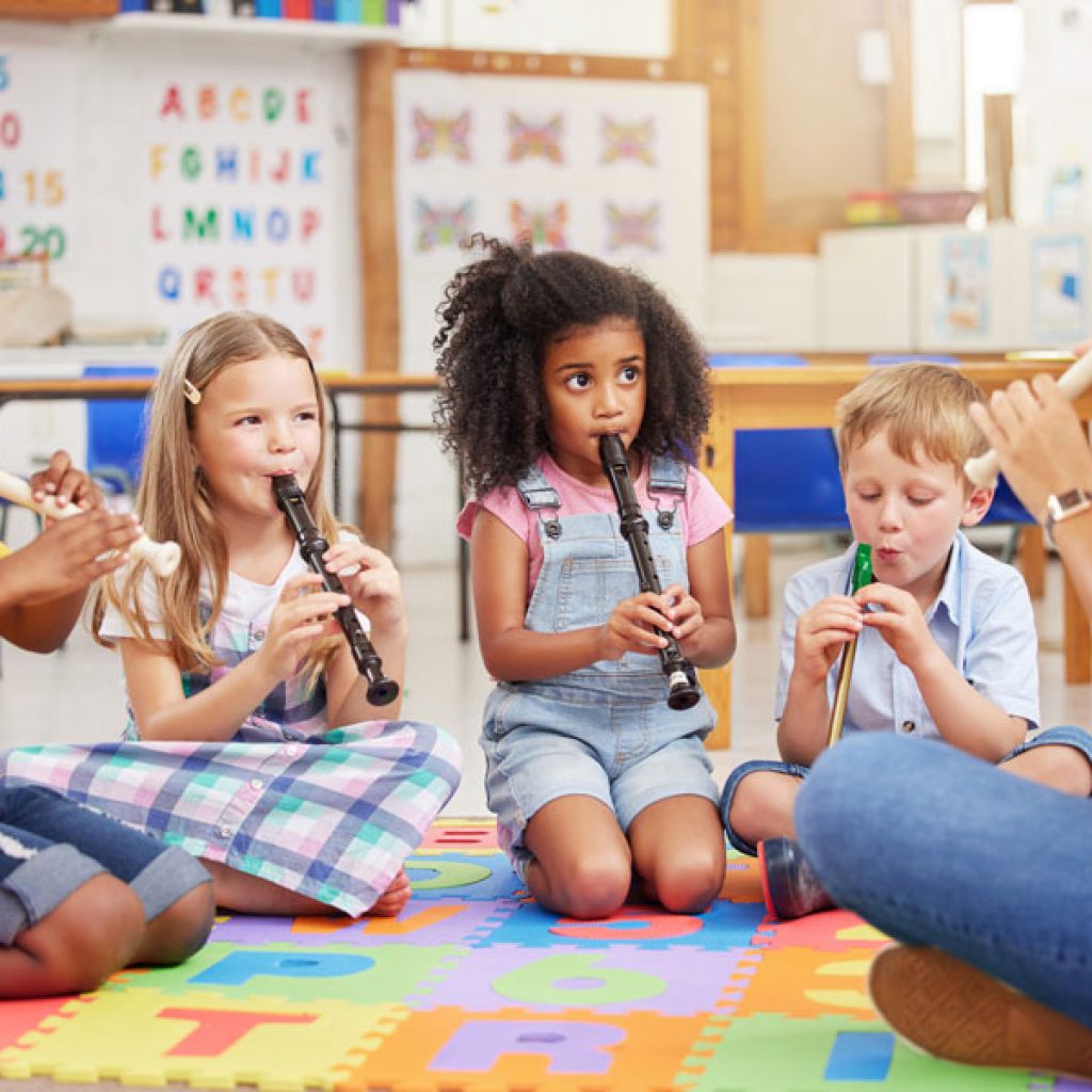 Children sitting in a music circle in a kindergarten class at Discovery Corner Academy